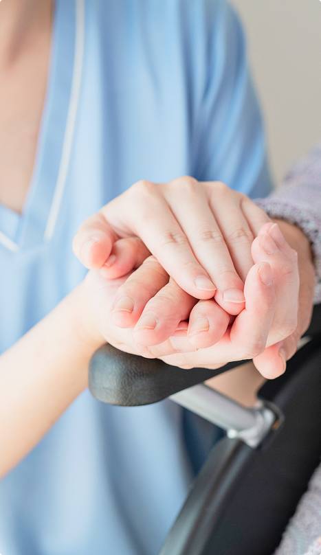 女性とおばあさんが手を繋いでいる様子
