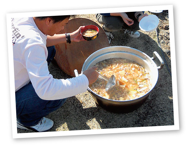 公式紹介に掲載された、屋外で芋煮を囲む風景