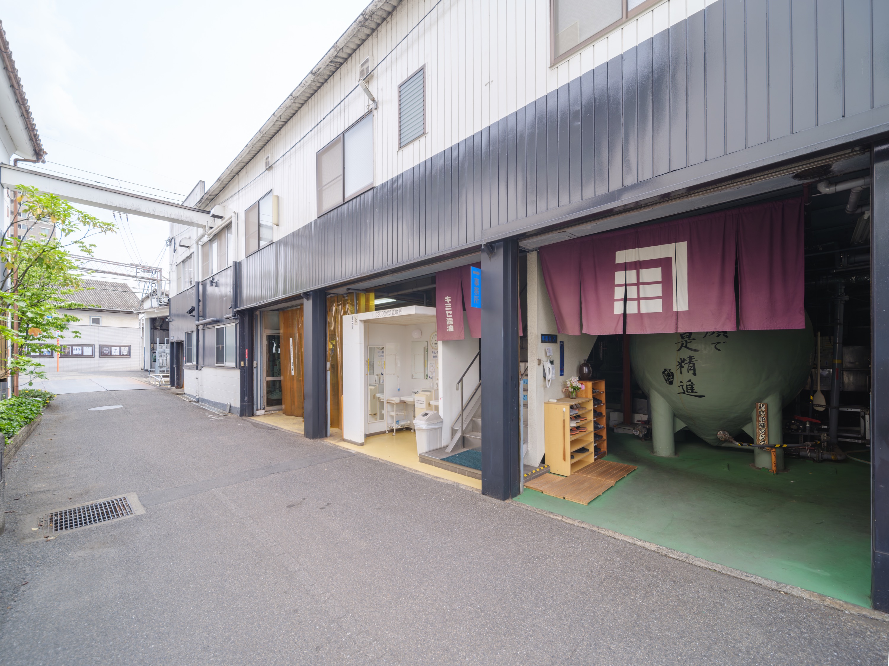 公式企業情報に掲載される、暖簾と醸造設備が見えるキミセ醤油本社の外観