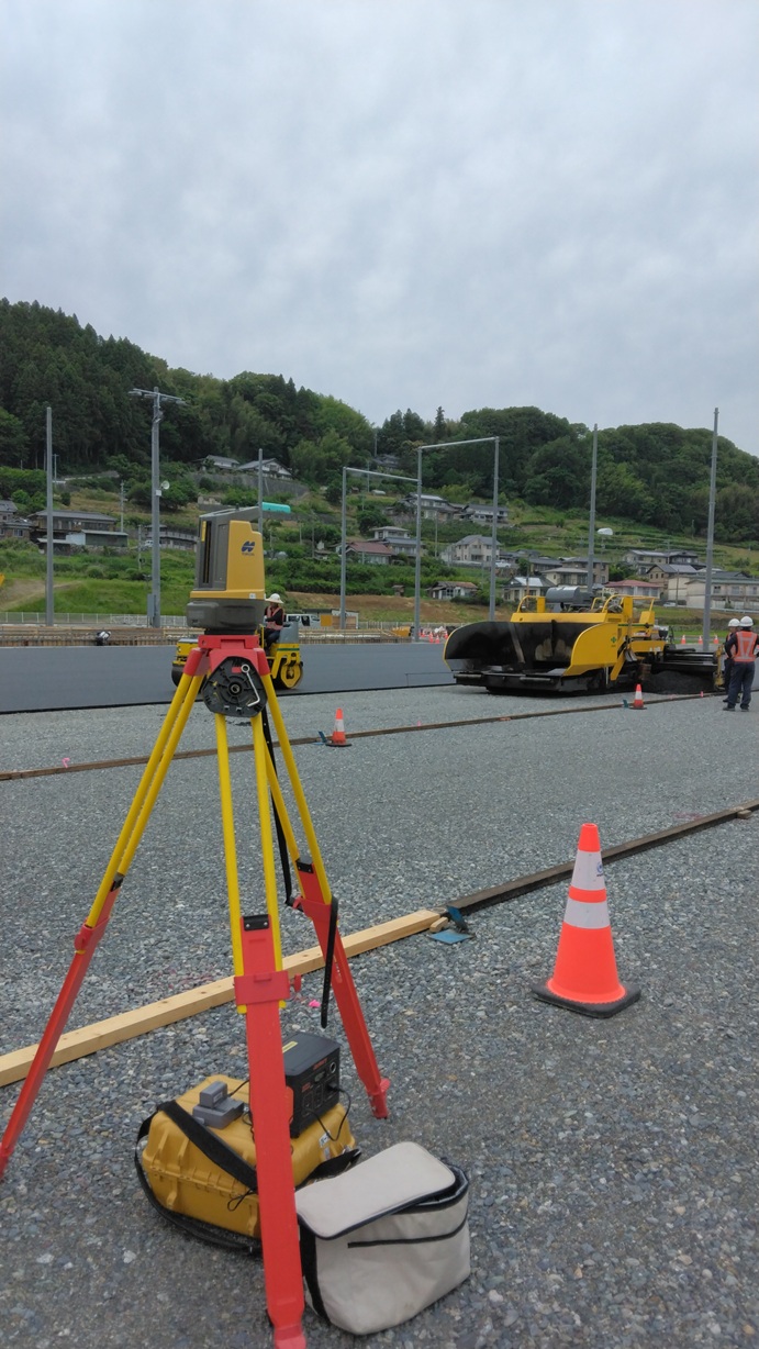 測量機器を使った舗装工事の現場