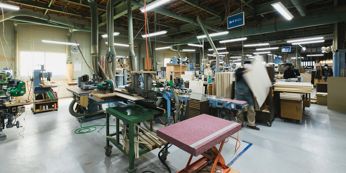 公式製造工場ページの、設備と作業中の現場を見渡す写真