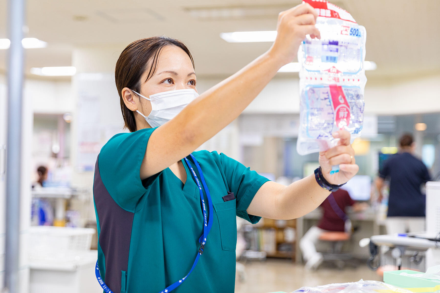 公式トップに掲載される、病棟で輸液を確認する看護スタッフ